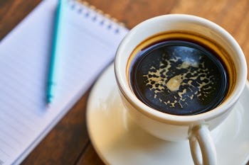 Flat Lay Photography of Cup of Coffee and Notebook