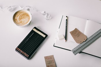 Flat Lay Photography of Grey Ruler on White Book