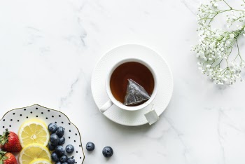 Flat Lay Photography of tea in White Teacup With Saucer