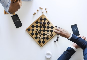 Flat Lay Photography of Two Men Playing Chess
