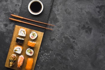 Flat lay sushi arrangement on slate background Free Photo