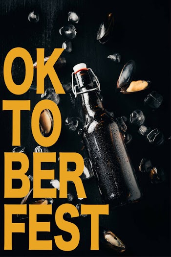 Flat lay with bottle of beer, mussels and ice cubes arranged on dark tabletop with "oktoberfest" lettering