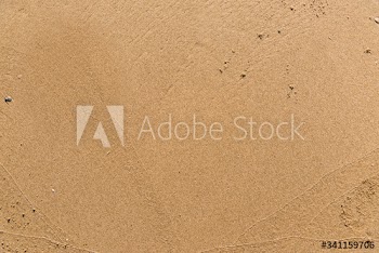 Flat sand on a beach textured backdrop