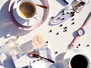 Flatlay Photography Of Coffee Mug Beside Watch 