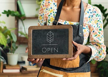 Florist shop owner holding open sign | Free stock photo | High Resolution image