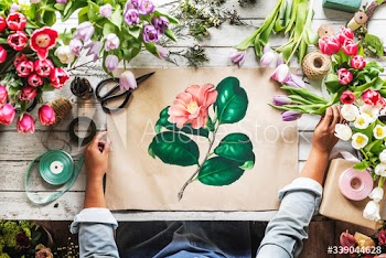 Florist Showing Empty Design Space Paper on Wooden Table with Fresh Flowers Decorate