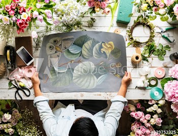 Florist Showing Empty Design Space Paper on Wooden Table with Fresh Flowers Decorate