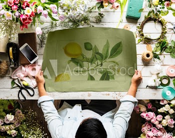 Florist Showing Empty Design Space Paper on Wooden Table with Fresh Flowers Decorate
