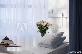 Flower bouquet next to hospital bed
