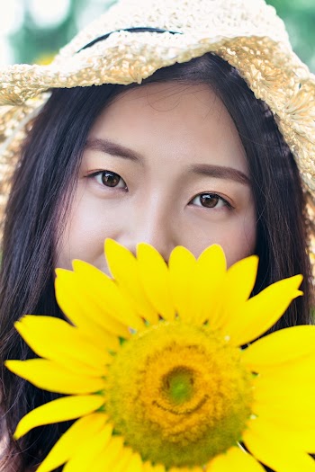 Flower Covering Woman's Mouth