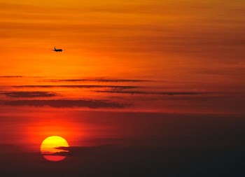 flying airplane during sunset