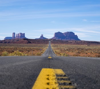 Focus Photo of Roadway Going Towards Mountains