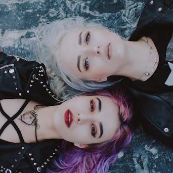 Focus Photo of Two Woman in Black Top