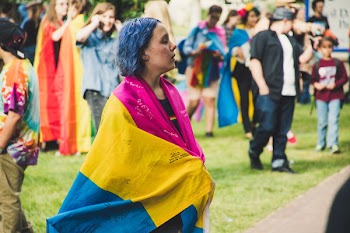 Focus Photo of Woman in Pink, Yellow, and Blue Dress