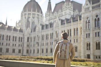 Focus Photography of Man Looking on White Concrete Building