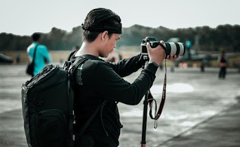 Focus Photography of Man Using Dslr Camera