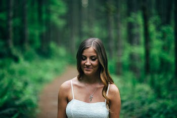 Focus Photography of Smiling Woman Wearing White Spaghetti Strap Top