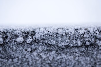focus photography of white snow on black surface