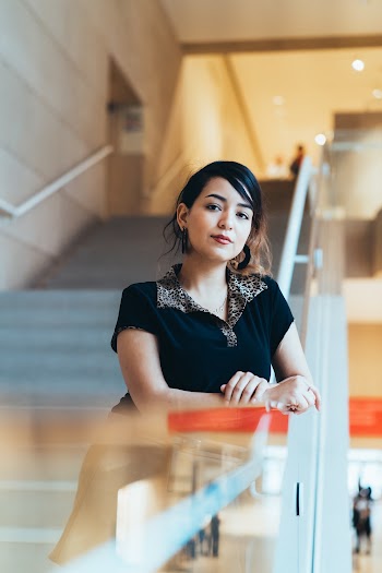 Focus Photography Of Woman Leaning On Stair Railing