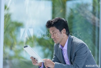Focused businessman using digital tablet on patio