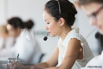 Focused businesswoman with headset in call center