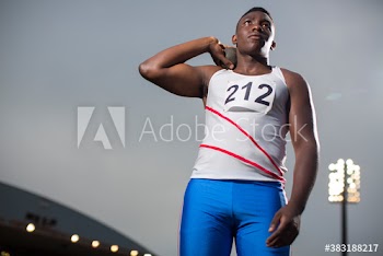 Focused male track and field athlete preparing for shot put