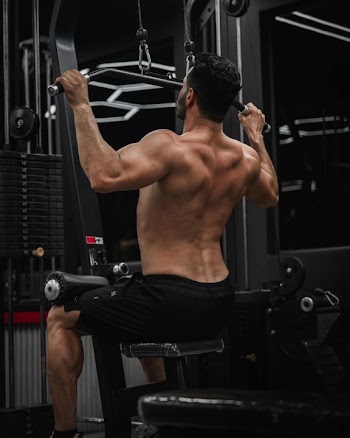 Focused Man Executing Pull-Ups in Gym