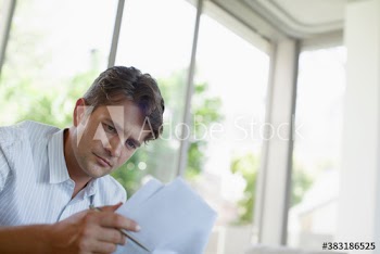Focused man reading paperwork