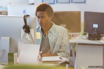 Focused young businessman working at computer in office