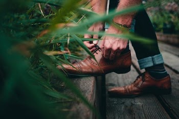 Footwear Close Up Man Tying Shoelace From Side