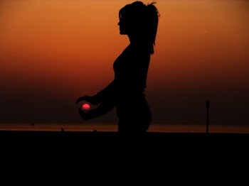 Force Perspective Photography of a Silhouette of a Woman Holding the Sun