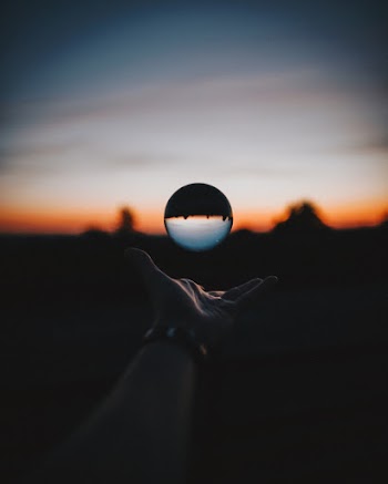 Force Perspective Photography of Sphere Glass during Sunset