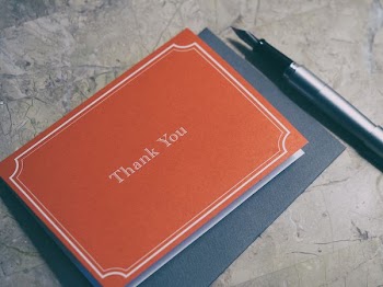 fountain pen next to red Thank You journal