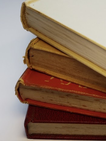 Four Assorted-color Hardbound Books