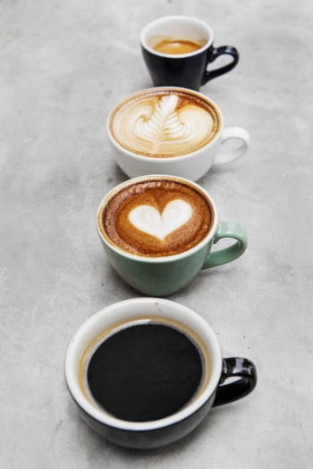 Four Assorted-color Mugs Filled With Liquids