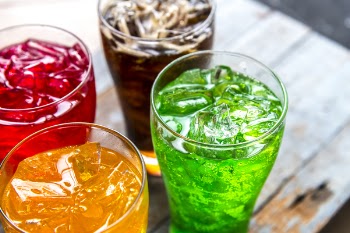 Four Assorted-flavored Drinks in Clear Drinking Glasses