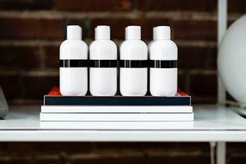 Four beauty product bottles on a shelf  | Free stock photo | High Resolution image