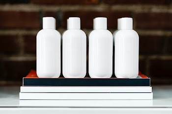 Four beauty product bottles on a shelf  | Free stock photo | High Resolution image