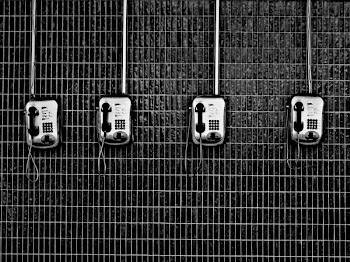 four black-and-grey telephones