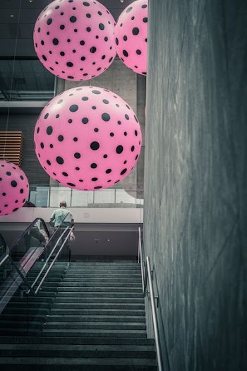 four black-and-pink balloons at daytime