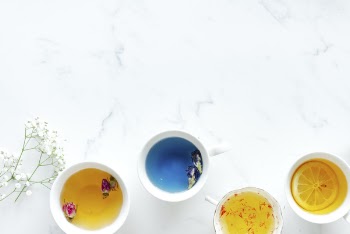 Four Ceramic Teacups Filled With Teas