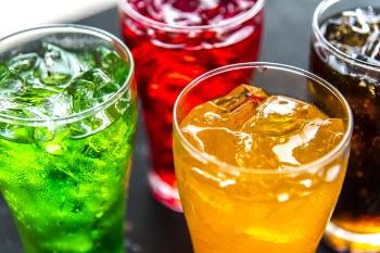 Four Clear Drinking Glasses Filled With Beverages