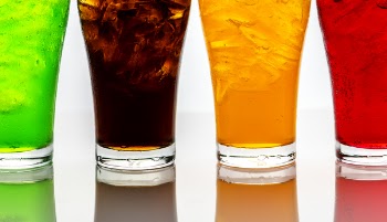 Four Drinking Glasses With Assorted Color Liquids