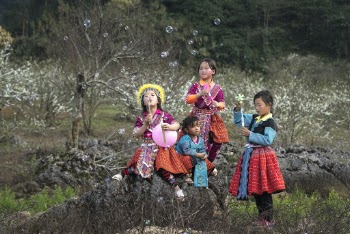 Four Girls in Tribal Dresses Near Grey Rocks