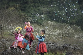 Four Girls Playing Bubbles on the Field