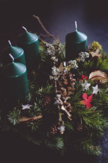 Four Green Pillar Candles Near Garland
