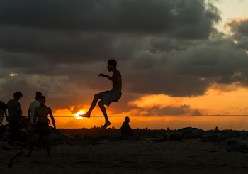 Four Men Playing on Shore