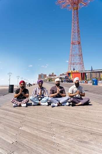 Four Men Sitting on Boardwalk