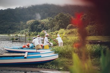 Four Men Standing Beside Boats