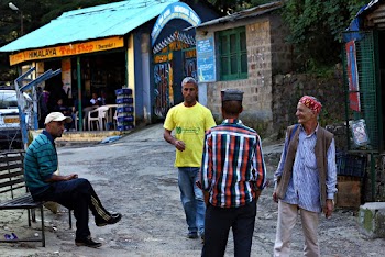 Four Men Talking in Front of Store